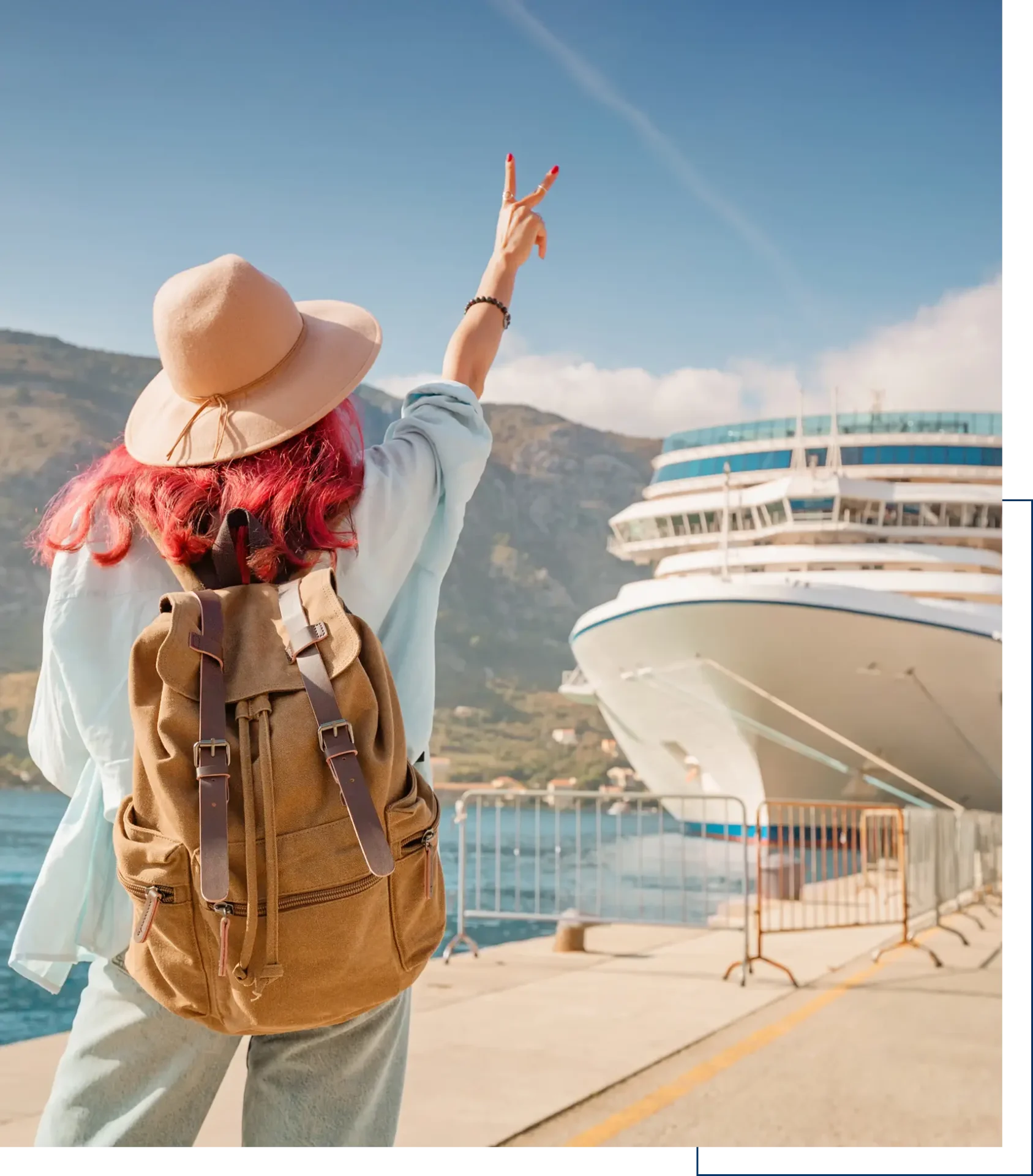 Backpacker posing beside large cruise ship